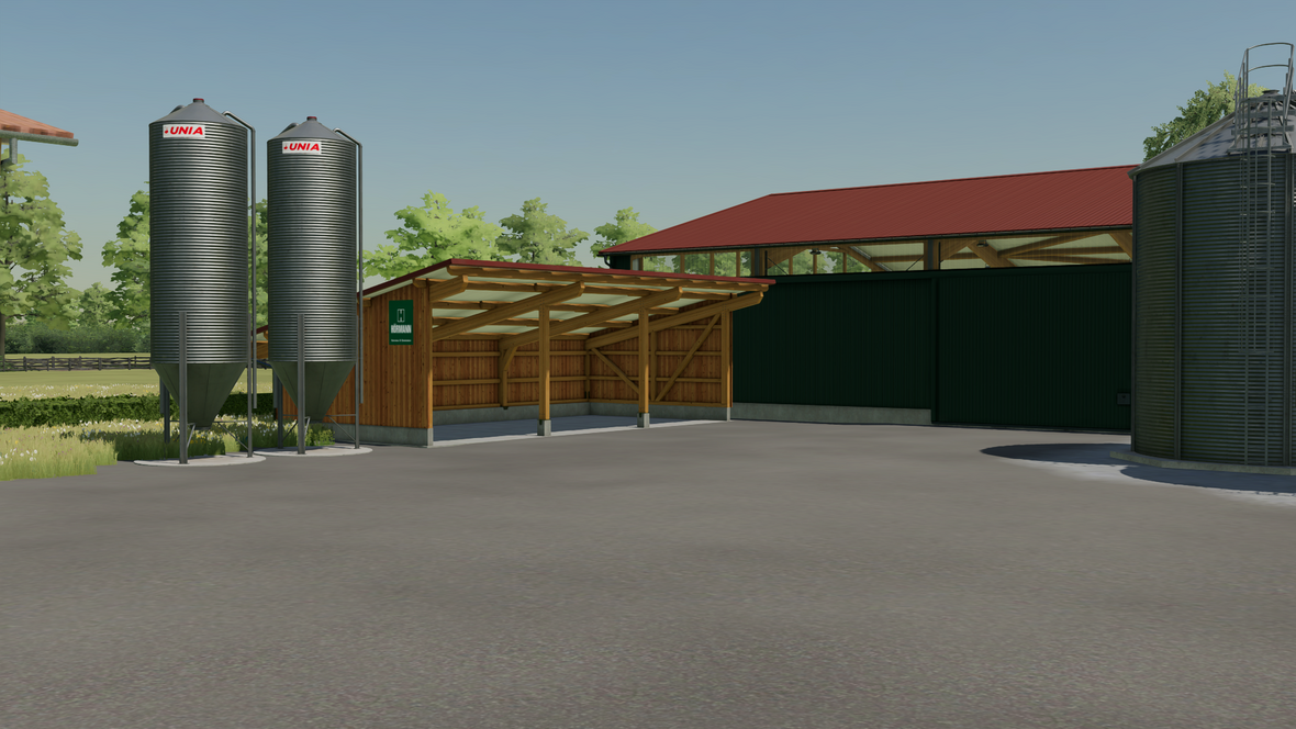 Teil der Maschinen und Lagerhalle mit angenzendem Unterstand und 2 Silos 