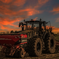 Drillen im Sonnenuntergang mit einen John  Derre 6R250